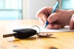 Person signing contract for car